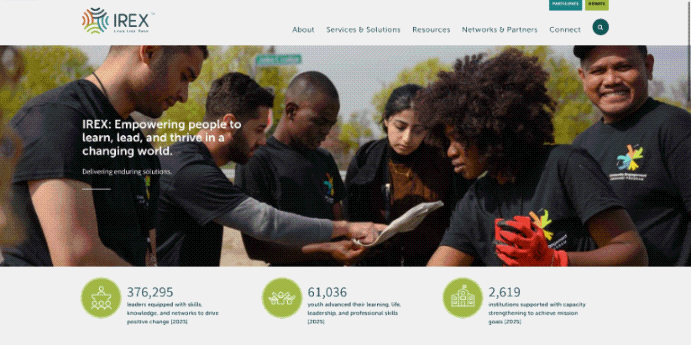 IREX website homepage displaying hero image of group working together and impact metric figures.