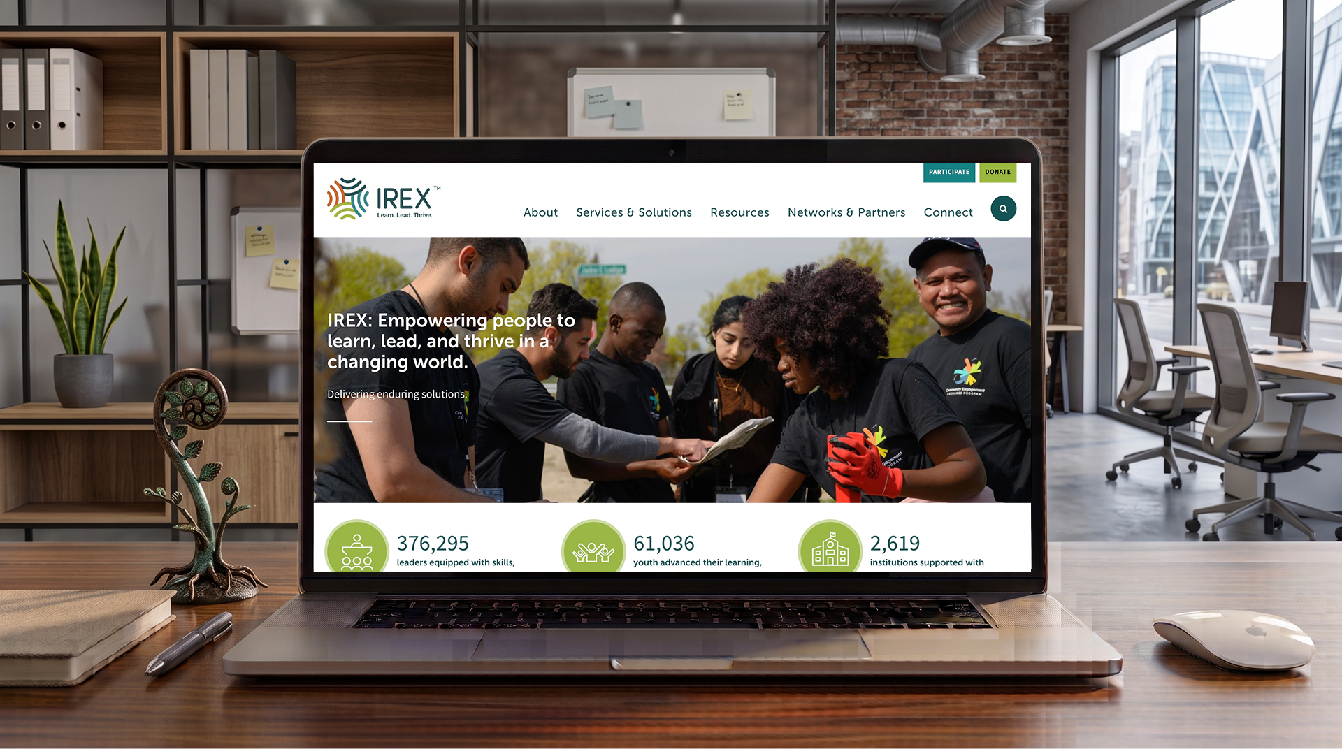 IREX website homepage shown on a laptop screen on a office desk.